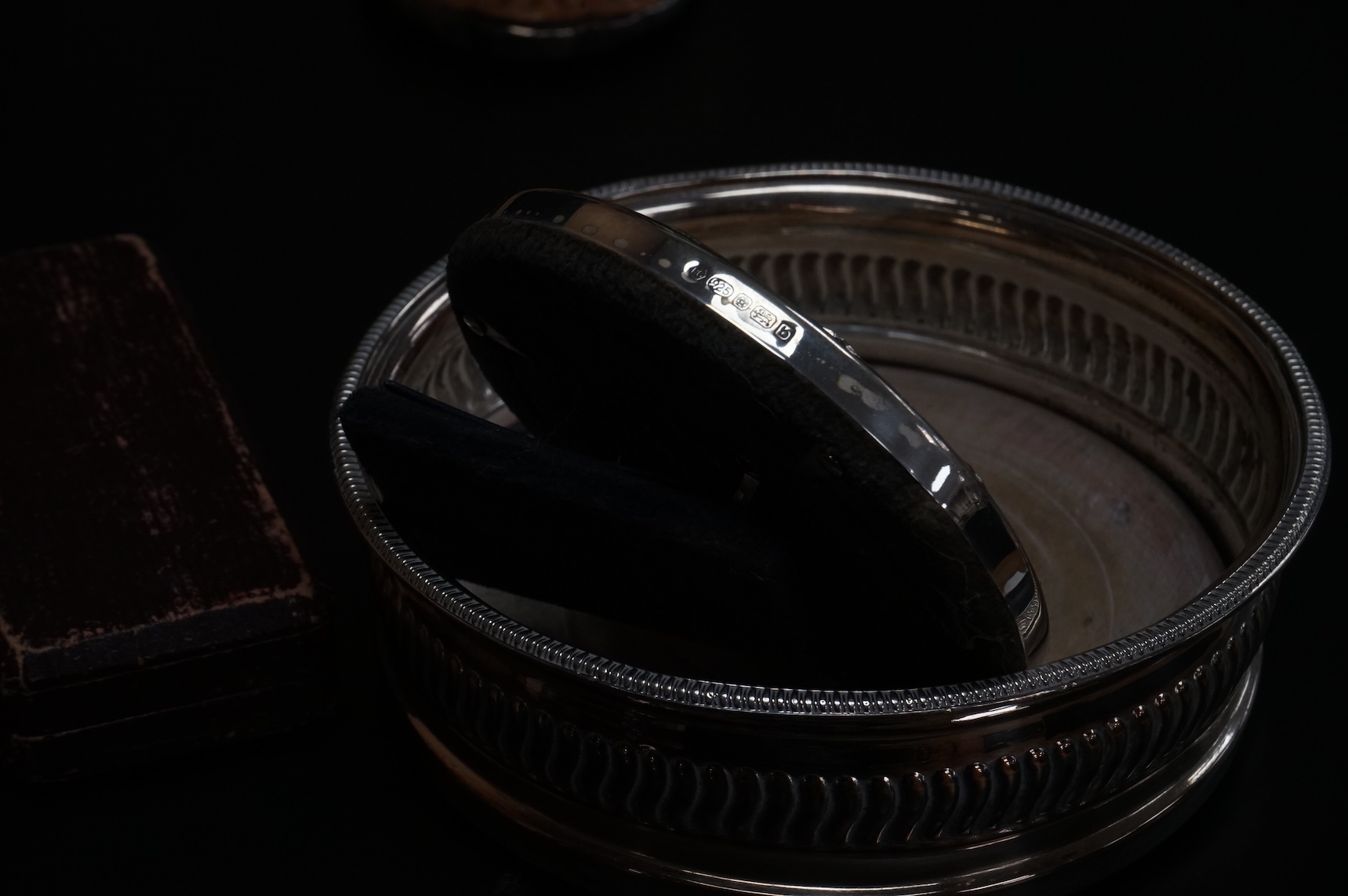 A George V silver rectangular card case by William Henry Sparrow, Birmingham, 1913, 89mm, a modern silver mounted circular photograph frame and five other items including a three piece silver plate and enamel mirror and